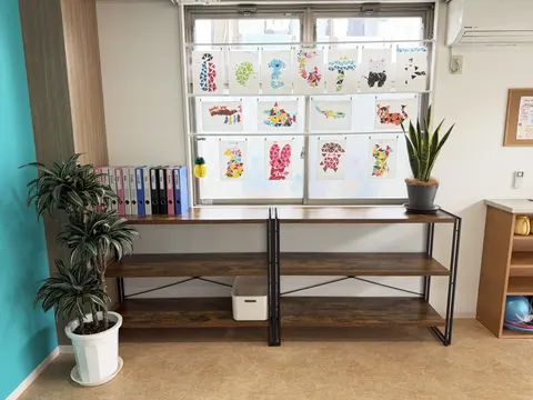 窓辺に飾られた子どもたちの作品と収納棚
